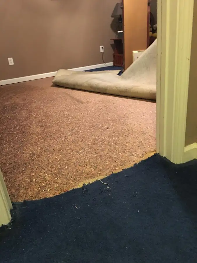 Carpet pad removal revealing water damage during Drying & Dehumidification in Merrill